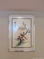 full view of framed embroidery artwork