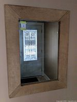 front view of framed mirror mounted on wall