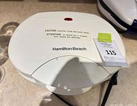 Closed Hamilton Beach grill showing exterior housing and brand logo