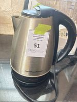 Full view of Hamilton Beach stainless steel electric kettle on its base
