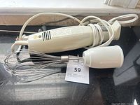 Full view of Hamilton Beach hand mixer with whisk attached