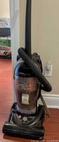 Front view showing Hoover Fold-Away upright vacuum, dust canister, hose, folding handle