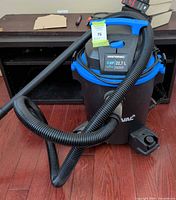 Overall view of Mastervac canister vacuum with hose attached