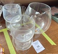 Front view showing all four glasses; chipped rim on large snifter visible