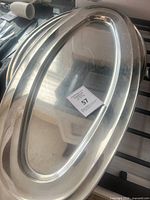 Large oval stainless steel platter with lot tag