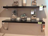 Front view showing both mounted black shelves with contents removed for scale