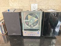 Front view of Sony CD player flanked by two speakers