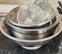 Stacked view showing colander, mixing bowl and food mill discs