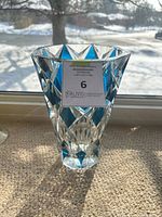 Front view of faceted cobalt blue crystal vase on windowsill