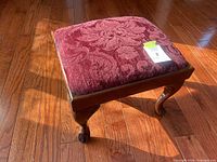 Top view showing burgundy patterned upholstery and wooden frame