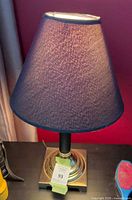 Front view of lamp illuminated showing full form and shade