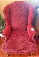 Front view of red damask wingback armchair