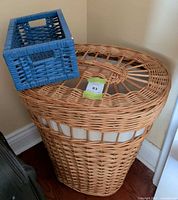 Hamper with lid in place next to blue basket on top