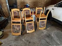 Stacked view of eight wood frame dining chairs with patterned upholstery