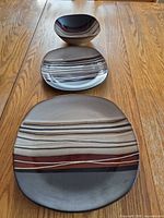 Three sizes of square stoneware pieces showing pattern and shape