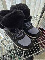 Front and top view of boots on shelf