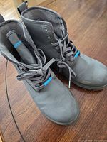 Native grey lace-up hiking boots showing uppers, laces and soles