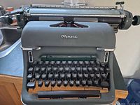 Front view of Olympia SM3 showing logo, keyboard, carriage