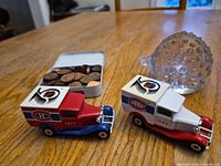 Group shot showing glass porcupine paperweight, two Montreal Canadiens model trucks, tin and pennies