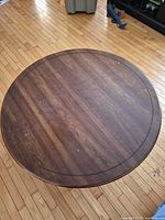 Top view of round coffee table showing surface wear and inlaid ring detail