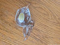 clear glass abstract figurine with gold label