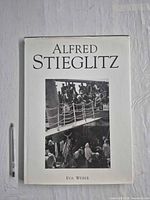 Front cover showing title, dust jacket intact, pen for scale