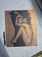 Front cover with Yoko Ono and John Lennon image next to pen for scale