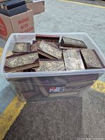 Plastic tote filled with antique marbled half-leather books