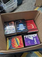Box showing five visible DVD cases