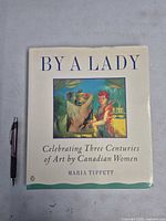 Front cover of paperback book with pen for scale