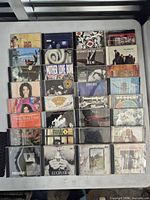 Overhead view of all 24 CD jewel cases arranged in six-by-four grid