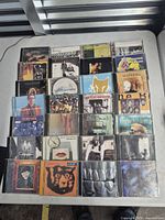 All 25 CDs laid out in grid on table