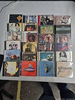 Full view of 20 CD cases laid out in 4x5 grid