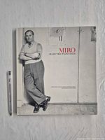 Front cover of hardcover book alongside pen for scale