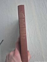 Spine view showing title, author, publisher on brown cloth