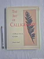 Front cover of hardcover book showing title, author and feather illustration