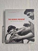 Front cover of hardcover book with pen for scale