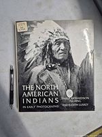 Front cover showing title, authors, Indigenous portrait, pen for scale