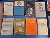 Eight hardcover books laid out showing full front covers