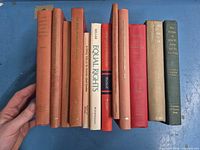 All 11 hardcover books spines visible