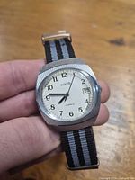 Front view of Vostok watch showing dial, hands, and strap