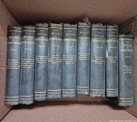 Front view of all nine volumes showing titles and spine wear