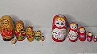 Both nesting doll sets lined up showing all pieces