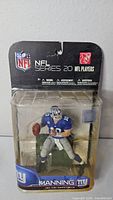 Front view of sealed Eli Manning NFL Series 20 figure in package