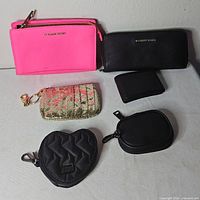 Group shot of all six wallets and pouches