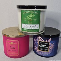 Front view of all three Bath & Body Works candles with lids