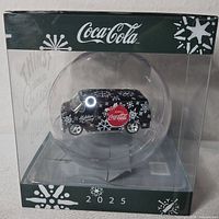 Boxed ornament showing clear sphere with die-cast van inside, Coca-Cola branding and 2025 marking