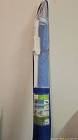 Umbrella stored in blue mesh carry bag