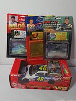 Group shot of die-cast car box and three hologram blister packs