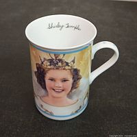 Front view showing Shirley Temple portrait, rim, handle and interior signature